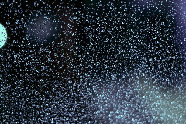 散焦玻璃和散景上的彩色雨滴。抽象的背景。库存图片图片下载