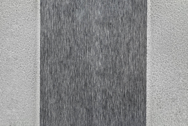 背景由粗糙和光滑的金属表面的微距照片。图片下载