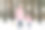 母亲和女儿走在冬天的雪林。快乐的妈妈和穿着粉色外套的小女孩手牵着手，在寒冷的冬日里享受着户外散步的乐趣。图片下载