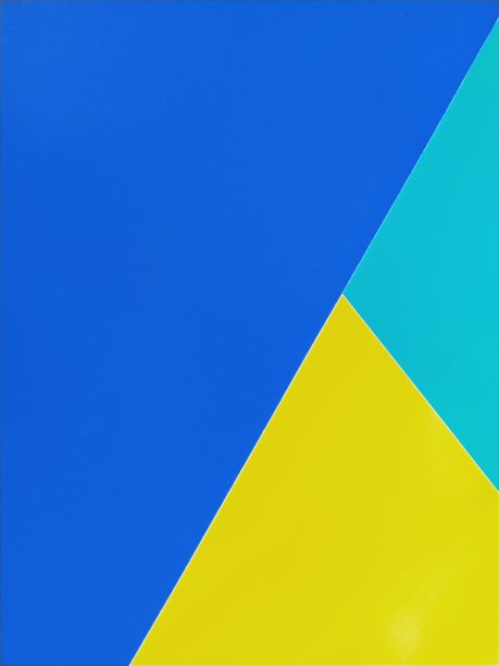 蓝色、绿色和黄色的纸叠在一起。彩色的背景图片下载