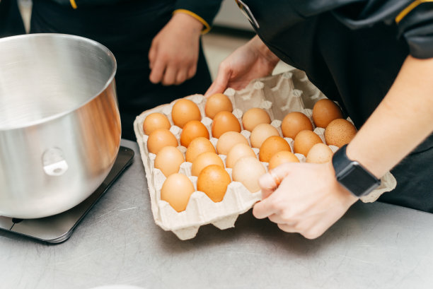 近距离照片，厨师拿着许多鸡蛋做煎蛋卷图片下载