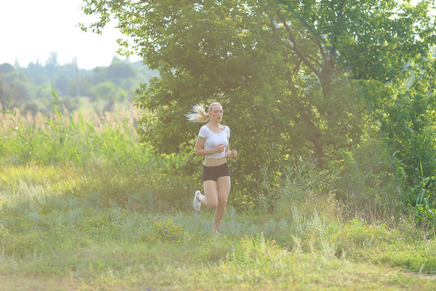 年轻美丽的女人跑步展示，压胃锻炼训练穿着上衣图片下载