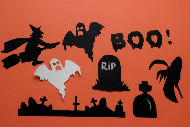 万圣节的节日。用不同的万圣节纸人物组成。从以上观点。橙色背景图片下载