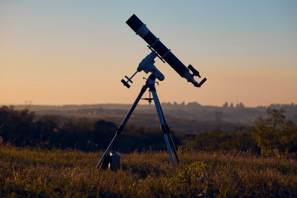 天文望远镜与乡村的剪影。图片下载
