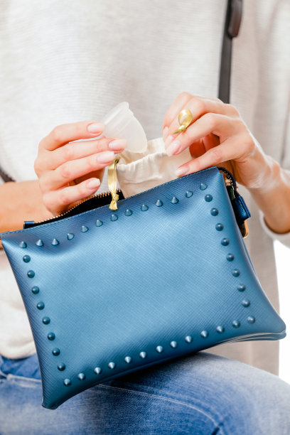 成年妇女把月经杯放在钱包里图片下载