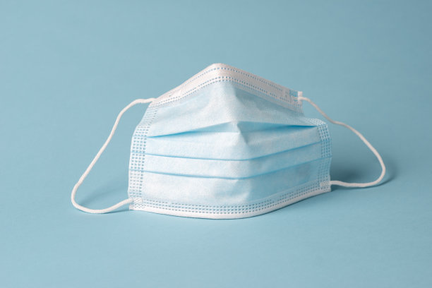 蓝色背景的蓝色医用口罩图片下载