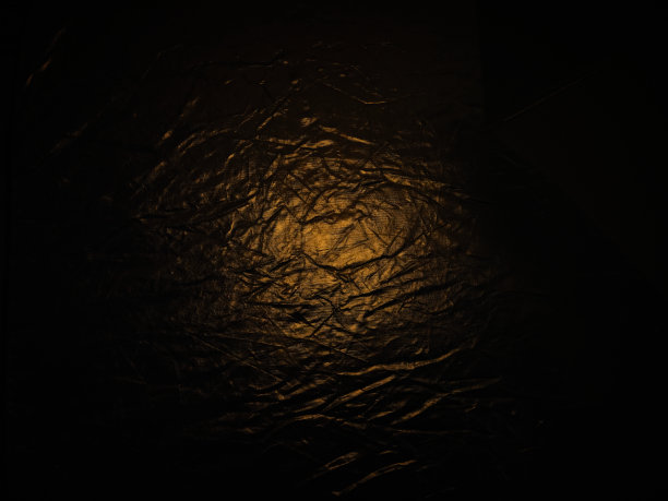 背景与皱纹的表面，小品超过金色的光图片下载