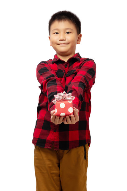 孩子穿着红色的t恤，微笑着拿着圣诞礼盒图片下载