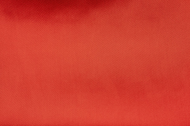 红色绸缎或真丝面料为底色，纺织材料为真丝。用于图案或背景图片下载