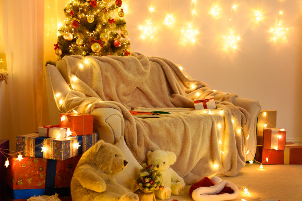 有新年或圣诞节装饰的室内。晚上，房间里亮着节日的彩灯。很多礼物和装饰品。寒假的概念图片下载