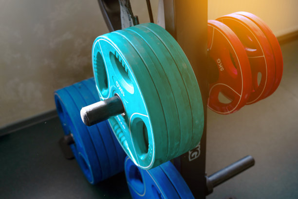 沉重的杠铃煎饼挂在架子上。图片下载