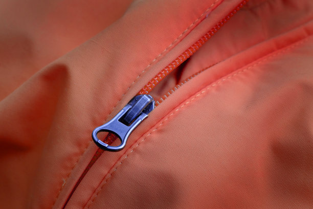 橙色夹克拉链上的服装时尚和设计图片下载