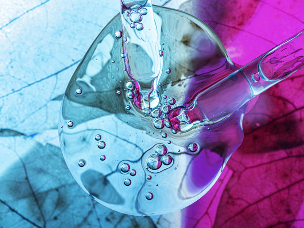 液体血清和滴管与叶子纹理的彩色背景。图片下载