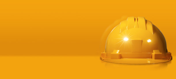 黄色背景上的橙色安全帽或安全帽图片下载