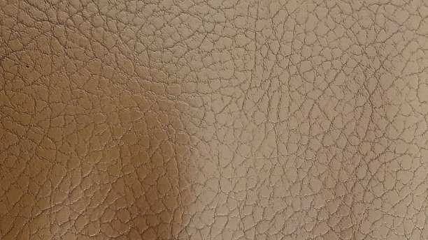 背景与皮肤纹理。闪亮的米色皮革背景特写。人造皮革米色光泽纹理。图片下载