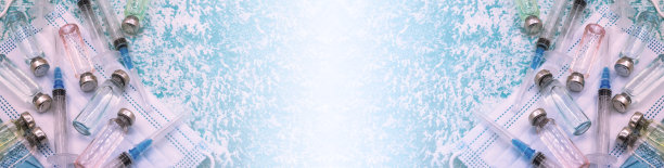 预防季节性疾病。绿色背景上的医用小瓶，注射器和口罩。疫苗接种covid-19。图片下载