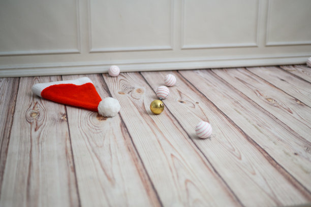 地板上放着圣诞老人的帽子和圣诞树玩具图片下载