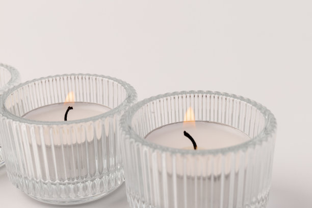 燃烧的茶蜡烛在一个玻璃烛台，孤立在白色。空间的文本图片下载