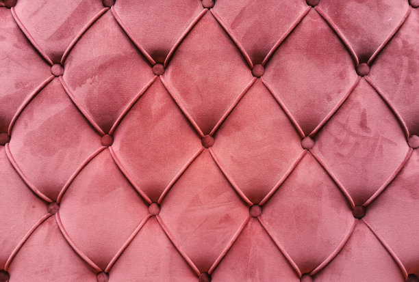 珊瑚色的纹理背景沙发。图片下载