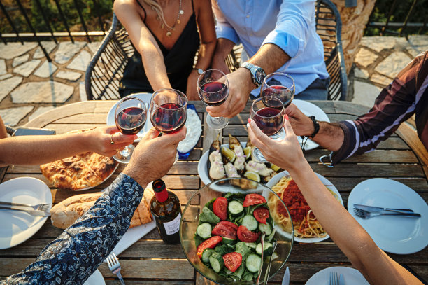 一群朋友在一起吃饭时一起敬酒图片下载