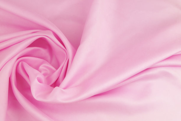 粉红色缎面织物背景。图片下载