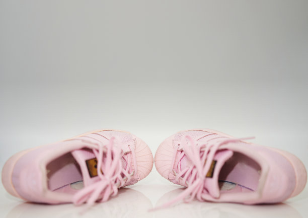 粉红色的运动鞋鞋与鞋带的侧视图在地板上软焦点与复制空间图片下载