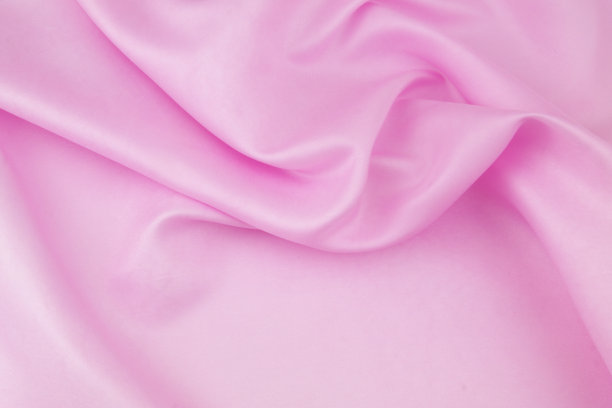 粉红色缎面织物背景。图片下载