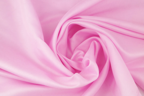 粉红色缎面织物背景。图片下载