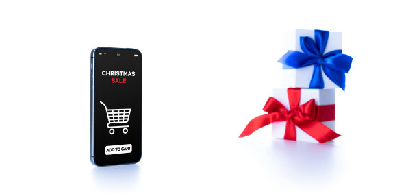 假日在线购物。网上商店应用程序在数字智能手机屏幕上与礼品盒红丝带在网上购物组成。圣诞快乐，恭贺新禧。图片下载