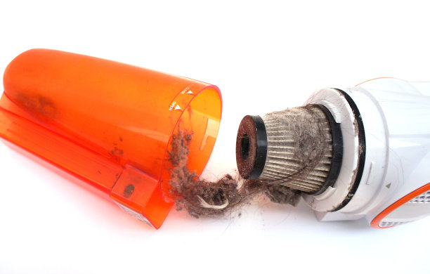 清洁手棒式吸尘器的集尘器。脏过滤器隔离在白色背景。关闭了。图片下载