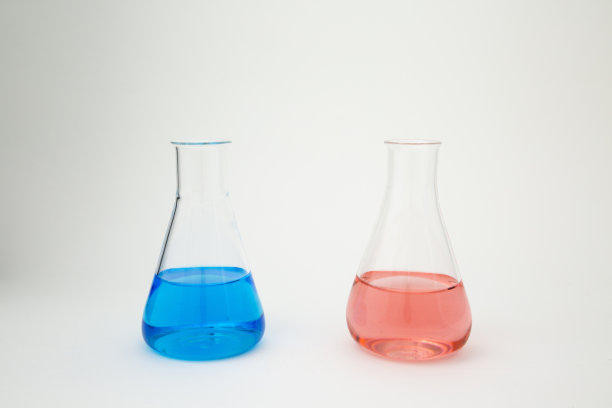 科学实验室玻璃锥形烧瓶充满蓝色和粉红色的液体在白色的背景。图片下载