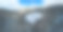 空中冬季景观与小乡村房屋之间的冰雪覆盖森林在寒冷的山区。图片下载