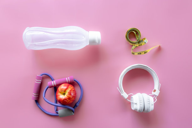 运动器材项目在粉红色的背景上，平铺。图片下载