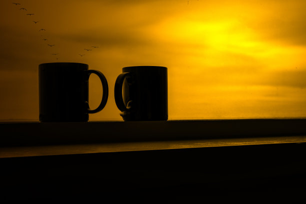 日落中的咖啡杯特写图片下载