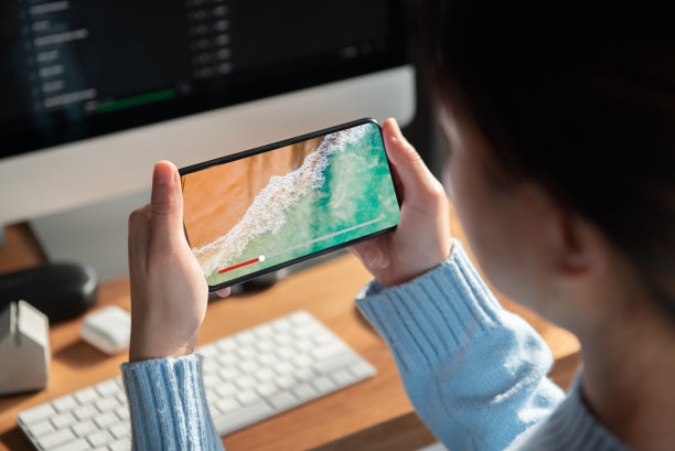 在线电影流与智能手机。女人用想象中的视频播放服务在手机上看电影。图片下载