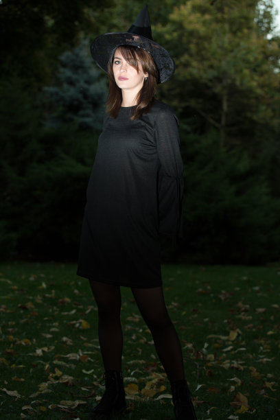美丽的女人，戴着黑色的帽子，穿着黑色的衣服。复古风格的时尚女孩。图片下载
