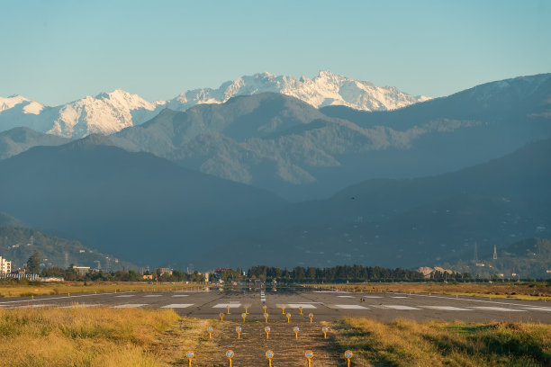 跑道上的背景山，雪峰在夕阳的光线，巴渡图片下载