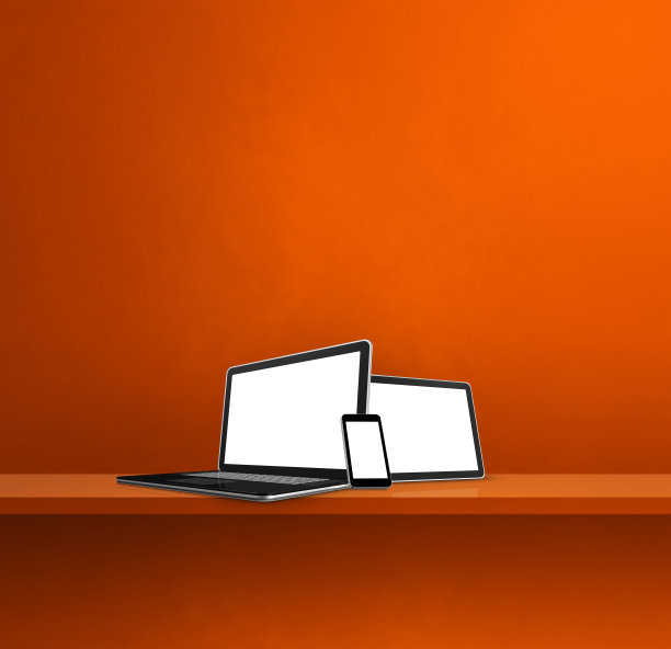 橙色壁柜上的笔记本电脑、手机和数字平板电脑。广场背景图片下载