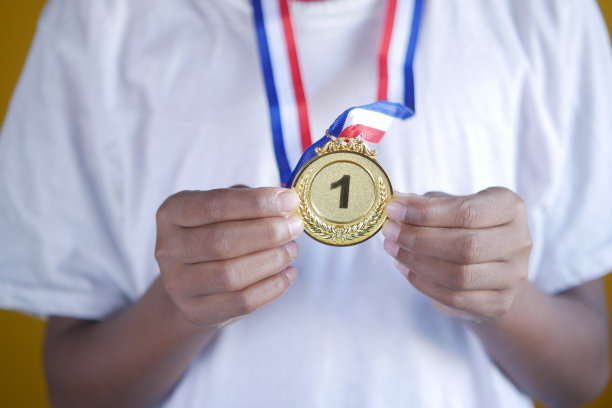 手握第一名Throphy对黄色背景图片下载