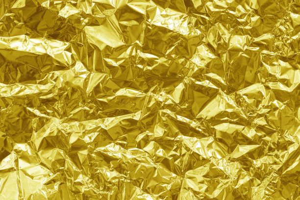 金光闪闪的金箔纹理背景，黄色包装纸图案带皱巴巴和波浪形。图片下载