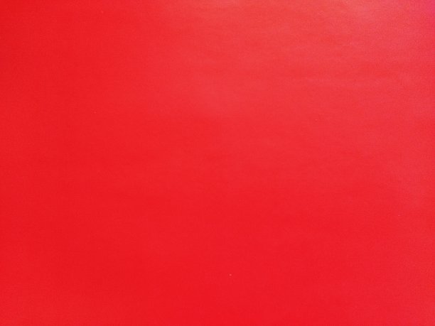 抽象红色背景或圣诞纸纹理。红色底座是情人节、新年或圣诞节卡片的颜色。颜色渐变图片下载