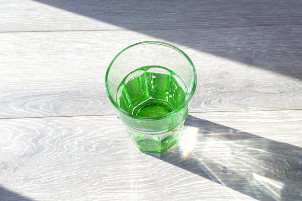 绿色玻璃水在阳光下的特写图片下载