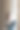 一个穿着白色毛衣和牛仔裤的快乐女孩坐在彩色玻璃窗上，这是一个砖砌的工业阁楼风格的室内。休闲的概念。图片下载