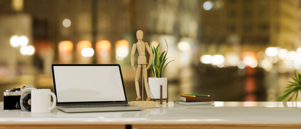 桌上的笔记本电脑，背景是模糊的城市夜光。图片下载