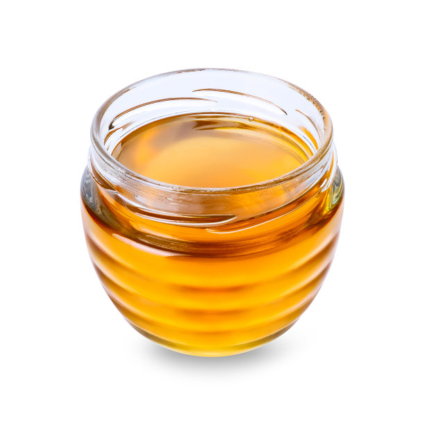 白色背景上有蜂蜜的玻璃罐图片下载