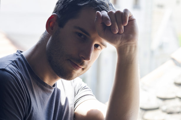 坐在窗边的年轻人的肖像图片下载