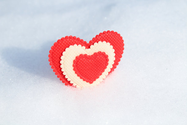 美丽的红色柔软的心布在雪。特写镜头。背景。纹理。孤立。图片下载