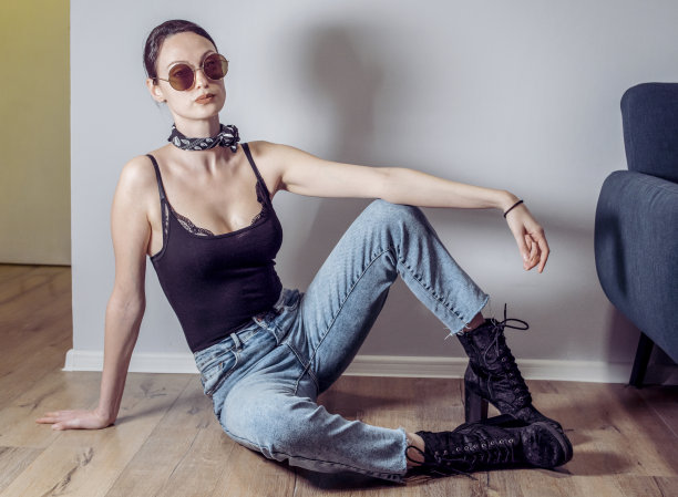 肖像一个有吸引力的时尚年轻的影响妇女坐在地板上图片下载