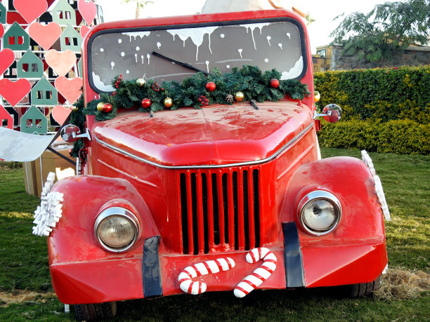 花园里装饰着新年节日服装的复古红色老爷车图片下载