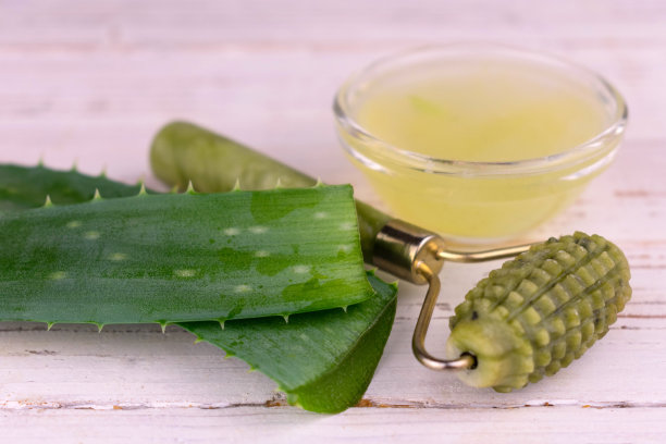 新鲜芦荟汁和面部按摩器。特写镜头。素材图片